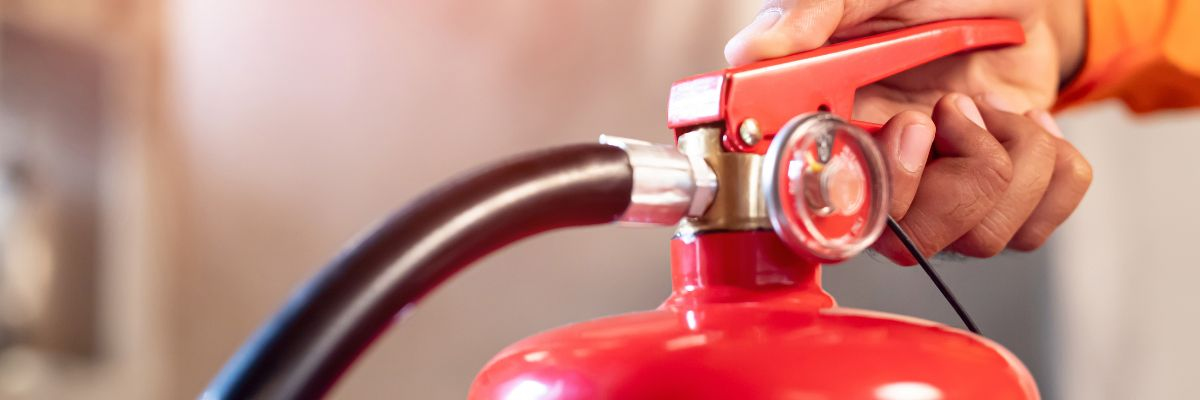 An image of fire extinguisher maintenance by Melwood Facilities.